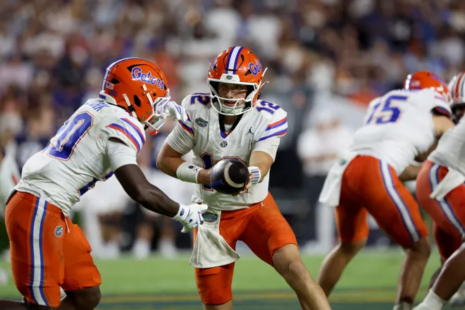 Sep 19, 2026; Auburn, Alabama, USA;  Florida Gators quarterback Aaron Philo (12) hands off to running back Duke Clark (20) during the third quarter against the Auburn Tigers at Jordan-Hare Stadium.  Mandatory Credit: John Reed-Imagn Images
