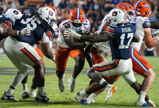 Florida Gators running back Jadan Baugh (13) runs the ball as Auburn Tigers take on Florida Gators at Jordan-Hare Stadium in Auburn, Ala. on Saturday, Sept. 19, 2026. Florida Gators defeated Auburn Tigers 44-39.