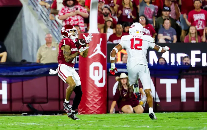 Sep 19, 2026; Norman, Oklahoma, USA; Oklahoma Sooners wide receiver Isaiah Sategna III (1) catches a touchdown pass past New Mexico Lobos safety Drew Speech (12) during the second half at Gaylord Family-Oklahoma Memorial Stadium. Mandatory Credit: Kevin Jairaj-Imagn Images
