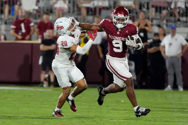 Oklahoma Sooners running back Lloyd Avant (9) fights off New Mexico Lobos safety Kevin Longstreet (20) during a college football game between the University of Oklahoma Sooners (OU) and the New Mexico Lobos at Gaylord Family-Oklahoma Memorial Stadium in Norman, Okla., Saturday, Sept. 19, 2026. Oklahoma won 14-6.