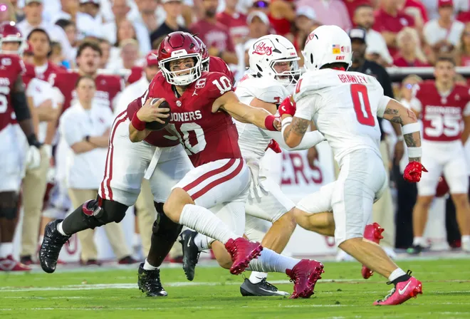 Sep 19, 2026; Norman, Oklahoma, USA; Oklahoma Sooners quarterback John Mateer (10) runs with the ball as New Mexico Lobos safety Austin Brawley (0) defends during the first quarter at Gaylord Family-Oklahoma Memorial Stadium. Mandatory Credit: Kevin Jairaj-Imagn Images