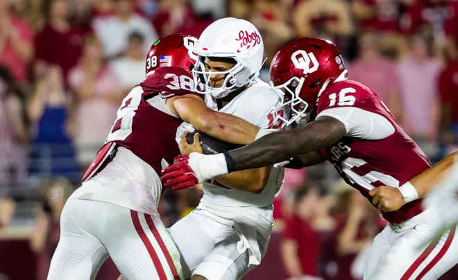 Sep 19, 2026; Norman, Oklahoma, USA; Oklahoma Sooners linebacker Owen Heinecke (38) and Oklahoma Sooners defensive lineman Danny Okoye (16) tackle New Mexico Lobos quarterback Toa Fa'avae (13) during the second half at Gaylord Family-Oklahoma Memorial Stadium. Mandatory Credit: Kevin Jairaj-Imagn Images