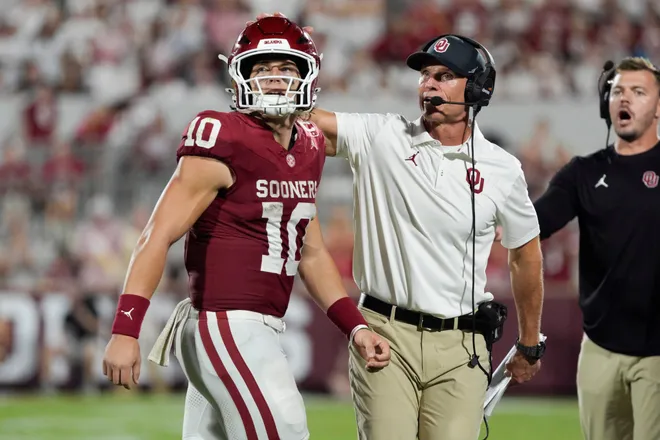 Oklahoma Sooners quarterback John Mateer (10) and coach Brent Venables talk after a play during a college football game between the University of Oklahoma Sooners (OU) and the New Mexico Lobos at Gaylord Family-Oklahoma Memorial Stadium in Norman, Okla., Saturday, Sept. 19, 2026. Oklahoma won 14-6.