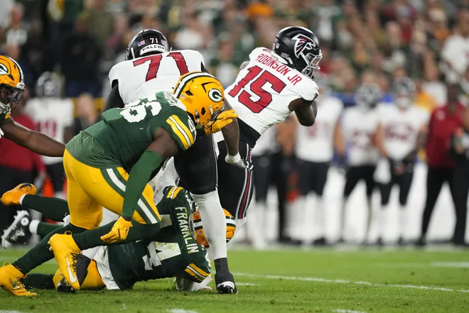 Sep 24, 2026; Green Bay, Wisconsin, USA;  Atlanta Falcons running back Brian Robinson (15) rushes the ball during the first quarter against the Green Bay Packers at Lambeau Field.  Mandatory Credit: Jeff Hanisch-Imagn Images