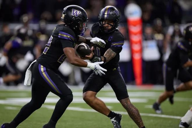 Sep 26, 2026; Seattle, Washington, USA;  Washington Huskies quarterback Demond Williams Jr. (1) hands off the ball in the first quarter against Minnesota Golden Gophers at Husky Stadium.  Mandatory Credit: Richard Dizon-Imagn Images