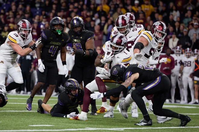 Sep 26, 2026; Seattle, Washington, USA;  Minnesota Golden Gophers running back Darius Taylor (1) is tackled in the first quarter at Husky Stadium.  Mandatory Credit: Richard Dizon-Imagn Images