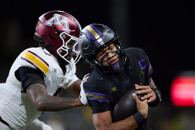 Sep 26, 2026; Seattle, Washington, USA;  Washington Huskies quarterback Demond Williams Jr. (1) is pushed by Minnesota Golden Gophers defensive back Zack Harden (4) into the sideline in the fourth quarter at Husky Stadium.  Mandatory Credit: Richard Dizon-Imagn Images