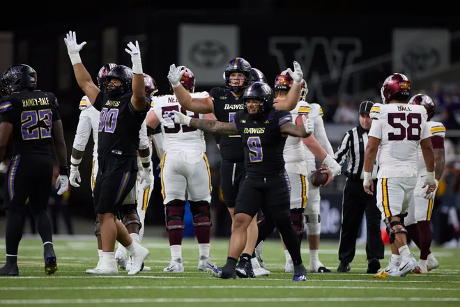 Sep 26, 2026; Seattle, Washington, USA;  Washington Huskies defensive lineman Elinneus Davis (90) and linebacker Jacob Manu (9) celebrate after a play against the Minnesota Golden Gophers during the third quarter at Husky Stadium.  Mandatory Credit: Richard Dizon-Imagn Images
