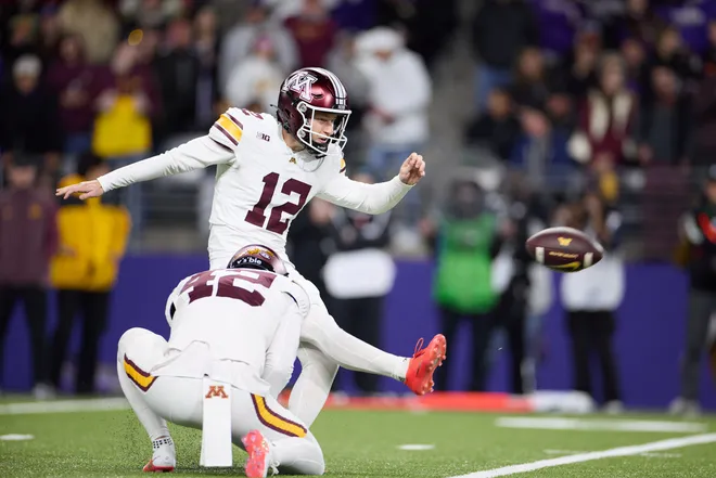 Sep 26, 2026; Seattle, Washington, USA;  Minnesota Golden Gophers kicker Luke Drzewiecki (12) kicks against the Washington Huskies in the first quarter at Husky Stadium.  Mandatory Credit: Richard Dizon-Imagn Images