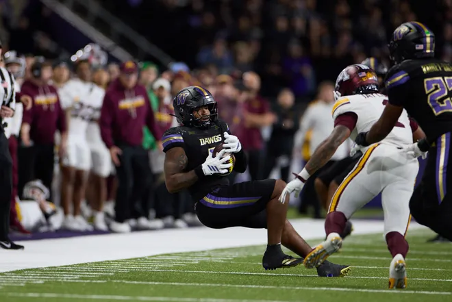 Sep 26, 2026; Seattle, Washington, USA;  Washington Huskies linebacker Taariq Al-Uqdah (0) catches an interception against the Minnesota Golden Gophers during the fourth quarter at Husky Stadium.  Mandatory Credit: Richard Dizon-Imagn Images