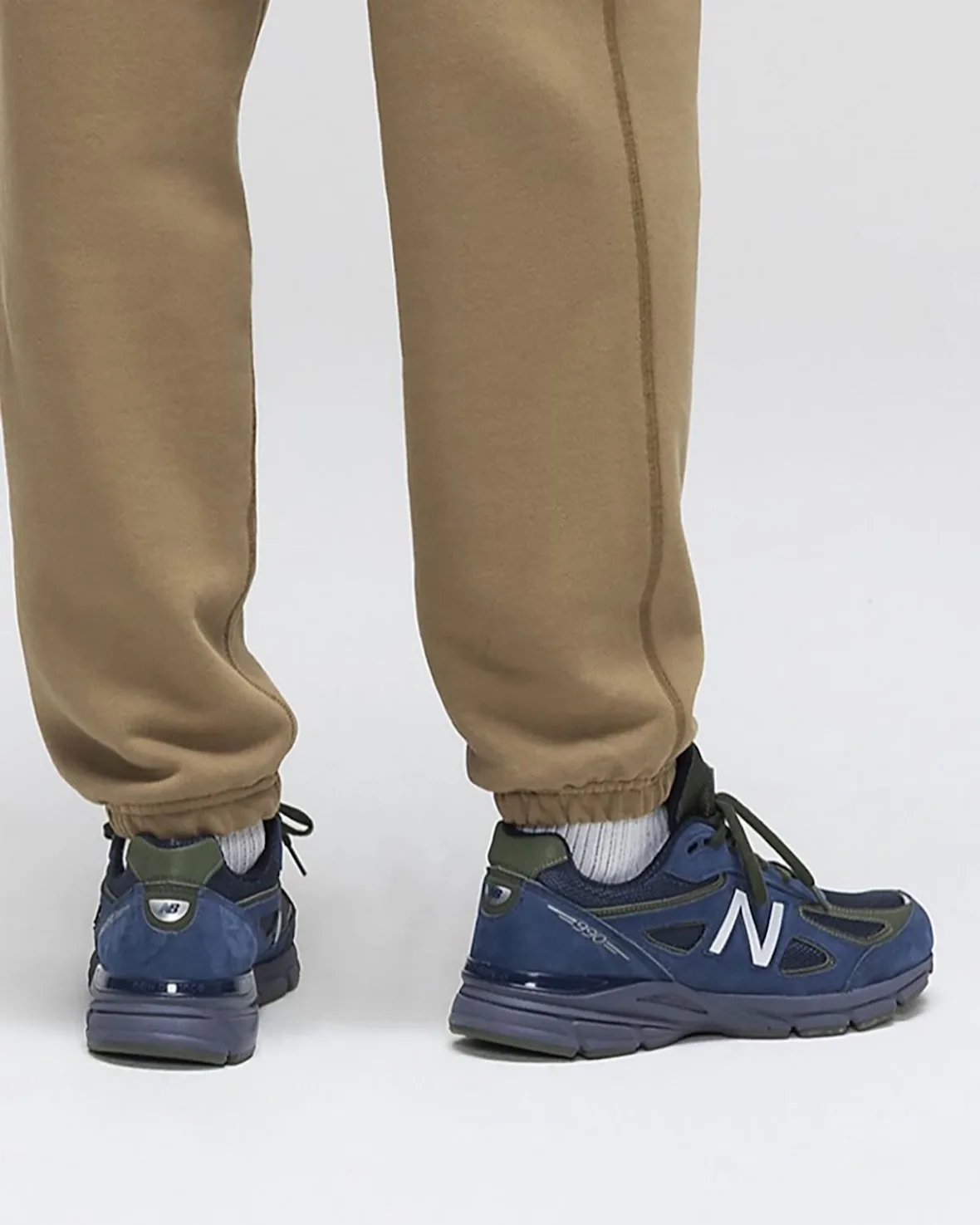 on-foot pair, angled 3/4 rear view, navy suede, olive heel tab, purple-grey midsole, Made in USA