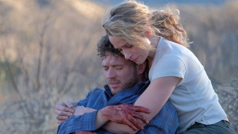 Bob Lee Swagger (Ryan Phillippe) crying with blood on his hands while Julie Swagger (Shantel VanSanten) embraces him in a scene from 