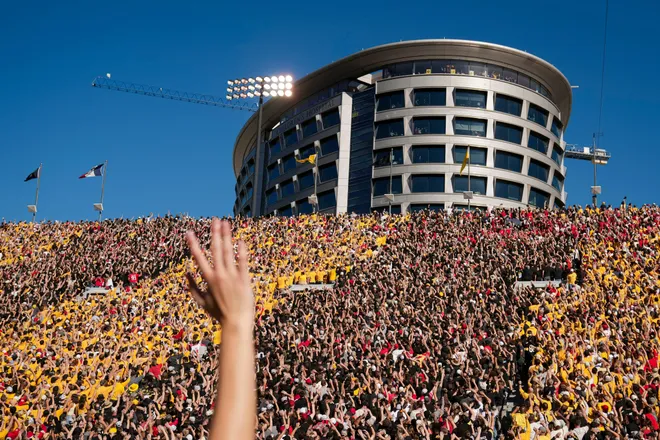 Fans wave to kids in the Iowa Children's Hospital during the NCAA football game between the Iowa Hawkeyes and the Ohio State Buckeyes at Kinnick Stadium in Iowa City on Oct. 3, 2026.