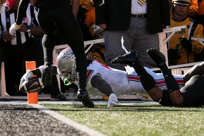 Ohio State Buckeyes wide receiver Jeremiah Smith (4) extends for a touchdown during the NCAA football game against the Iowa Hawkeyes at Kinnick Stadium in Iowa City on Oct. 3, 2026.