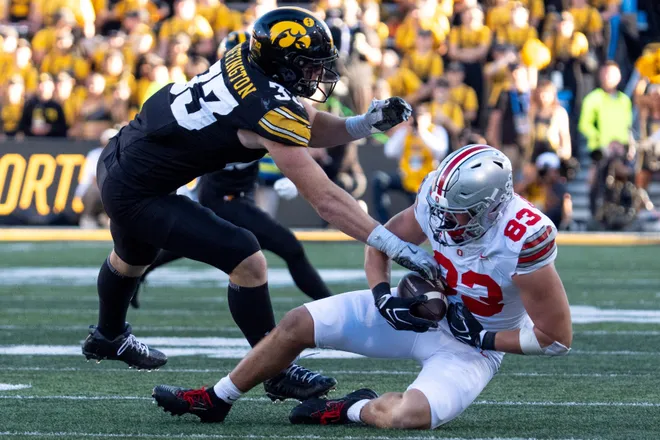 Ohio State Buckeyes tight end Nate Roberts (83) catches a pass as Iowa Hawkeyes linebacker Cam Buffington (33) defends Oct. 3, 2026 at Kinnick Stadium in Iowa City, Iowa.