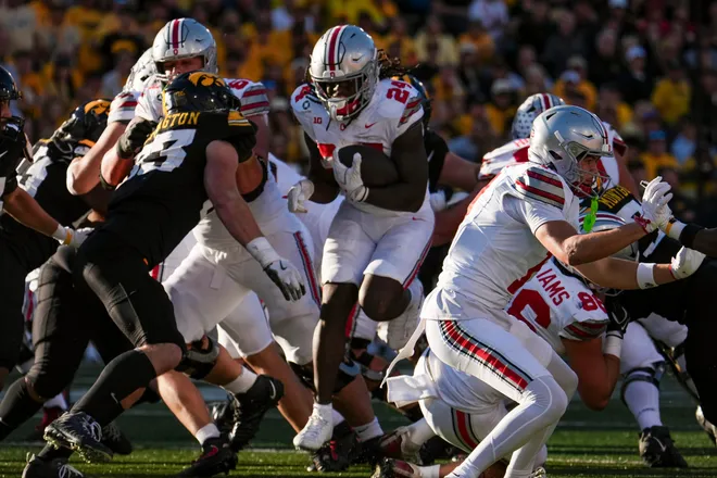 Ohio State Buckeyes running back Ja'kobi Jackson (24) leaps through the line of scrimmage during the NCAA football game against the Iowa Hawkeyes at Kinnick Stadium in Iowa City on Oct. 3, 2026. Ohio State on 31-14.