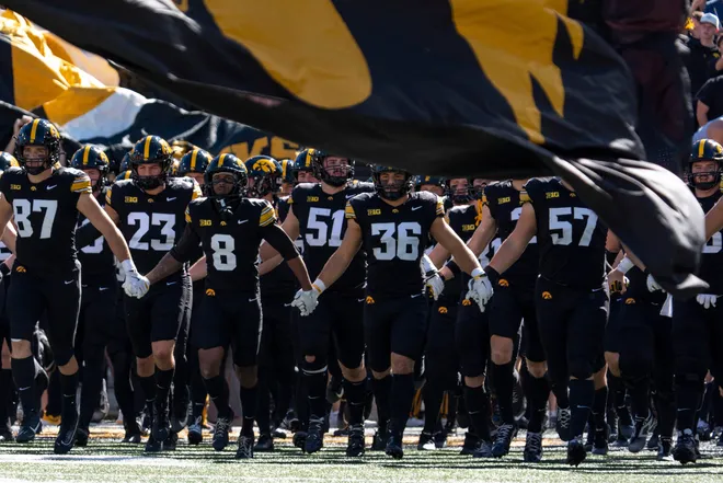 The Iowa Hawkeyes swarm onto the field during a Big Ten college football game against the Ohio State Buckeyes Oct. 3, 2026 at Kinnick Stadium in Iowa City, Iowa.