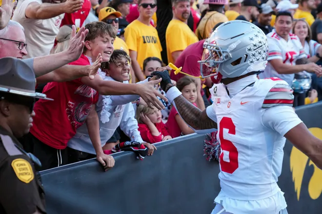 Ohio State Buckeyes cornerback Devin Sanchez (6) celebrates with fans during the NCAA football game against the Iowa Hawkeyes at Kinnick Stadium in Iowa City on Oct. 3, 2026. Ohio State on 31-14.