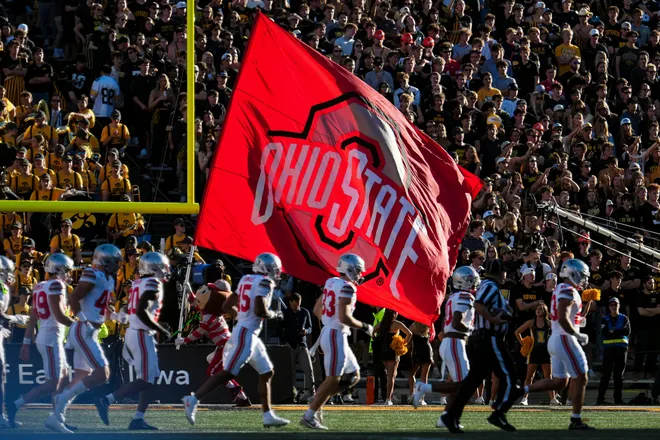 Ohio State Buckeyes mascot Brutus carries a flag during the NCAA football game against the Iowa Hawkeyes at Kinnick Stadium in Iowa City on Oct. 3, 2026. Ohio State on 31-14.