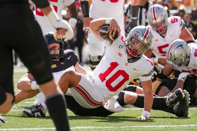 Ohio State Buckeyes quarterback Julian Sayin (10) scrambles forward during the NCAA football game against the Iowa Hawkeyes at Kinnick Stadium in Iowa City on Oct. 3, 2026.