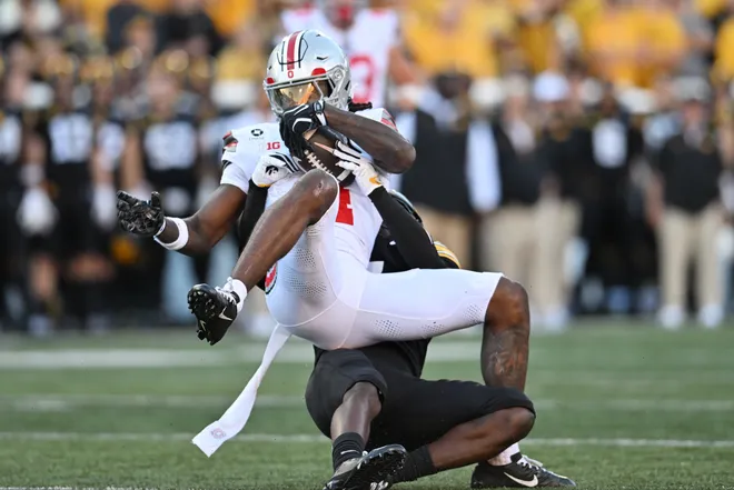 Oct 3, 2026; Iowa City, Iowa, USA;  Iowa Hawkeyes defensive back Rashad Godfrey Jr. (7) tackles Ohio State Buckeyes wide receiver Jeremiah Smith (4) during the second half at Kinnick Stadium.  Mandatory Credit: Jeffrey Becker-Imagn Images