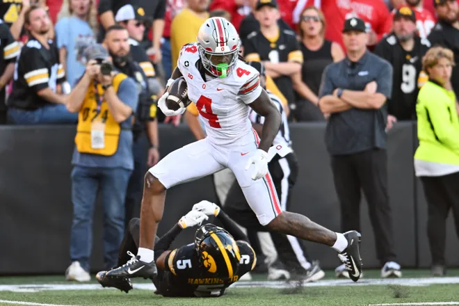 Oct 3, 2026; Iowa City, Iowa, USA;  Ohio State Buckeyes wide receiver Jeremiah Smith (4) runs against Iowa Hawkeyes defensive back Anthony Hawkins (5) during the second half at Kinnick Stadium.  Mandatory Credit: Jeffrey Becker-Imagn Images