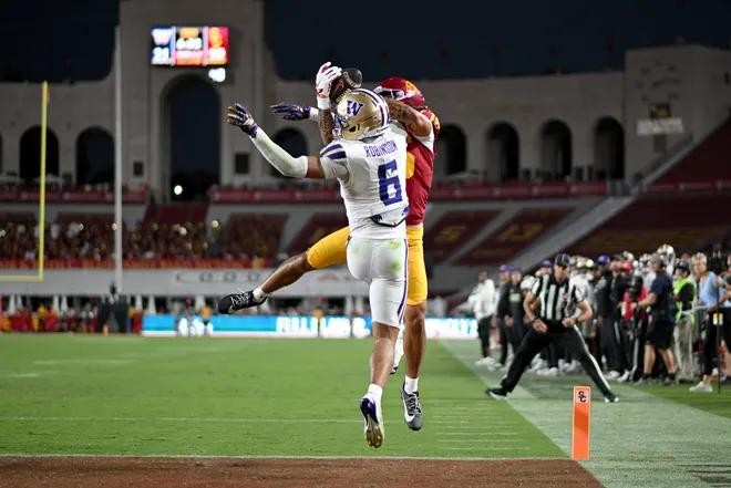Oct 3, 2026; Los Angeles, California, USA;  USC Trojans wide receiver Tanook Hines (16) scores a touchdown against Washington Huskies cornerback Dylan Robinson (6) during the third quarter at United Airlines Field at Los Angeles Memorial Coliseum.  Mandatory Credit: Griffin Hooper-Imagn Images
