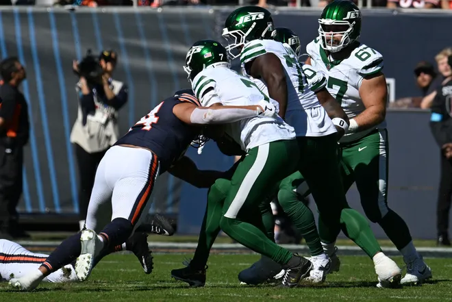Oct 4, 2026; Chicago, Illinois, USA;  Chicago Bears defensive line Austin Booker (94) sacks New York Jets quarterback Geno Smith (7) during the second quarter at Soldier Field.  Mandatory Credit: Matt Marton-Imagn Images