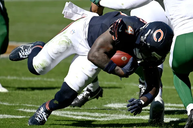 Oct 4, 2026; Chicago, Illinois, USA;  Chicago Bears running back D'Andre Swift (4) loses his footing against New York Jets cornerback Azareye'h Thomas (1) during the second quarter at Soldier Field.  Mandatory Credit: Matt Marton-Imagn Images