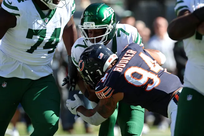 Oct 4, 2026; Chicago, Illinois, USA;  Chicago Bears defensive line Austin Booker (94) tackles New York Jets quarterback Geno Smith (7) during the second quarter at Soldier Field.  Mandatory Credit: Mike Dinovo-Imagn Images