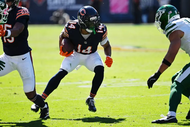 Oct 4, 2026; Chicago, Illinois, USA;  Chicago Bears wide receiver Kalif Raymond (14) runs with the ball against the New York Jets during the second quarter at Soldier Field.  Mandatory Credit: Matt Marton-Imagn Images