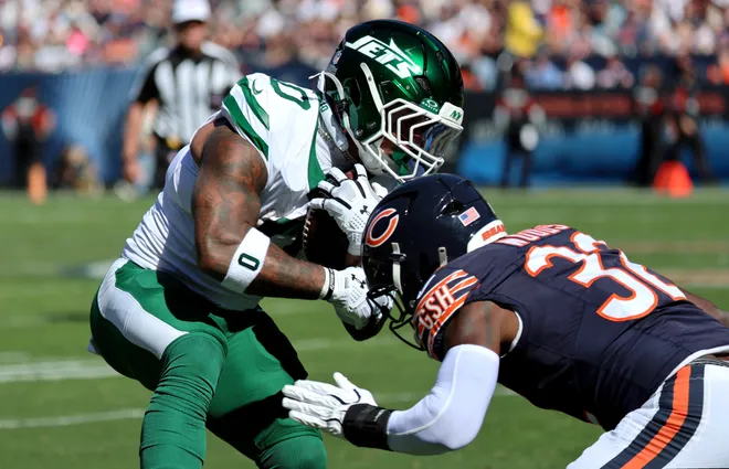 Oct 4, 2026; Chicago, Illinois, USA;  Chicago Bears safety Xavier Woods (32) tackles New York Jets running back Braelon Allen (0) during the second quarter at Soldier Field.  Mandatory Credit: Mike Dinovo-Imagn Images