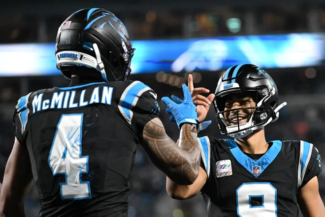 Oct 4, 2026; Charlotte, North Carolina, USA;  Carolina Panthers wide receiver Tetairoa McMillan (4) celebrates with quarterback Bryce Young (9) after scoring a touchdown against the Detroit Lions during the third quarter at Bank of America Stadium.  Mandatory Credit: Bob Donnan-Imagn Images