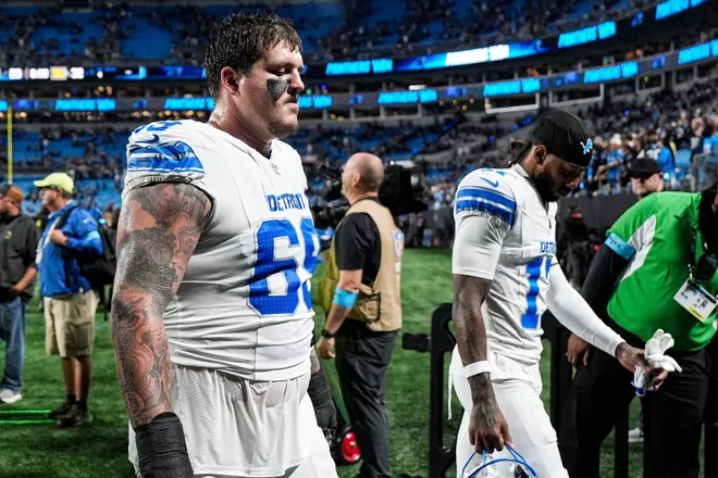Detroit Lions offensive lineman Tate Ratledge (69) next to wide receiver Tay Martin (17) walk off the field after a 32-26 loss to the Carolina Panthers at Bank of America Stadium in Charlotte on Sunday, Oct. 4, 2026.