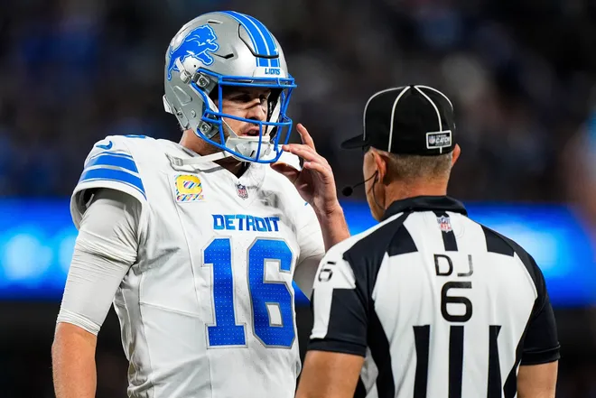 Detroit Lions quarterback Jared Goff (16) talks to a referee regarding a play against the Carolina Panthers during the first half at Bank of America Stadium in Charlotte on Sunday, Oct. 4, 2026.