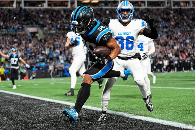 Carolina Panthers running back Chuba Hubbard (30) runs for a touchdown against Detroit Lions safety Chuck Clark (36) during the first half at Bank of America Stadium in Charlotte on Sunday, Oct. 4, 2026.